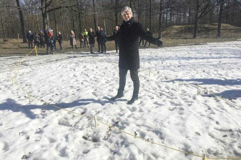 This handout picture released March 25, 2019 by Vestfold Fylkeskommune shows Norwegian Minister of Climate and Environment Ola Elvestuen posing at the place where a ship's grave probably originated from the Viking Age has been discovered