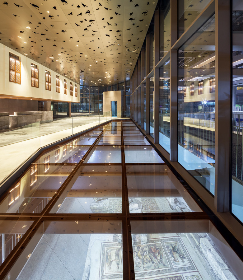 Through the glass reveals in the hotel lobby, visitors can glimpse rubbled walls and an ancient streambed in addition to the mosaics.