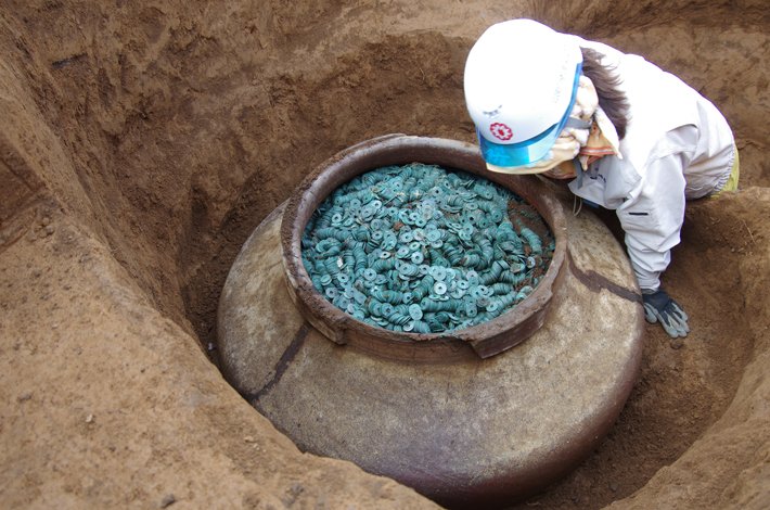 A Ceramic Jar Filled with Thousand of bronze coins Unearthed at the site of a 15th-century Samurai Residents