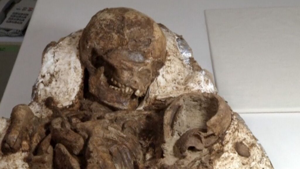 Archaeologists discover 4,800-year-old fossil of a mother cradling a baby