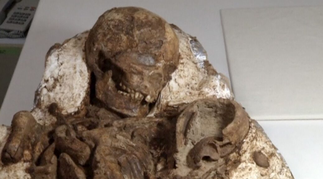 Archaeologists discover 4,800-year-old fossil of a mother cradling a baby