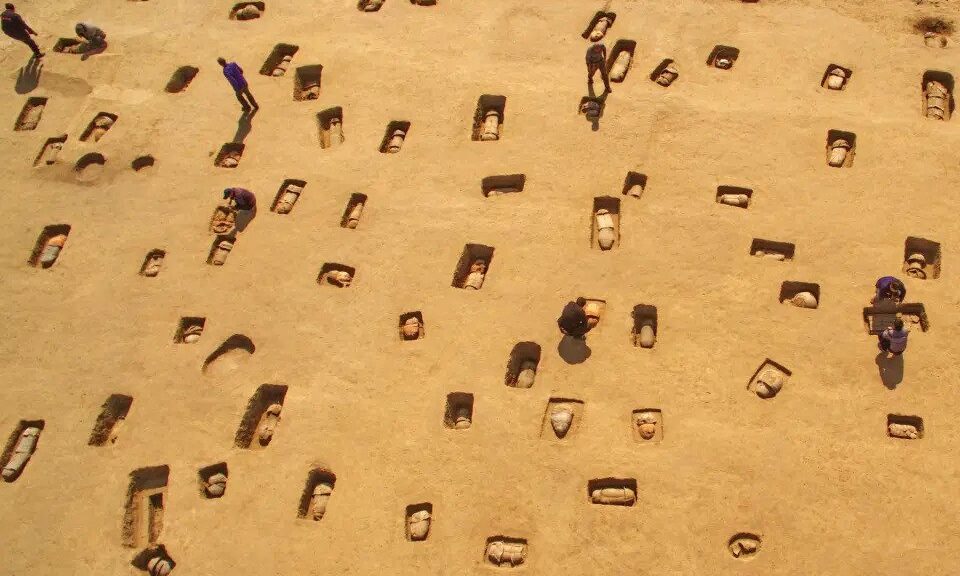 Haunting pictures show a mass grave of 113 ancient human remains buried in clay pots in China