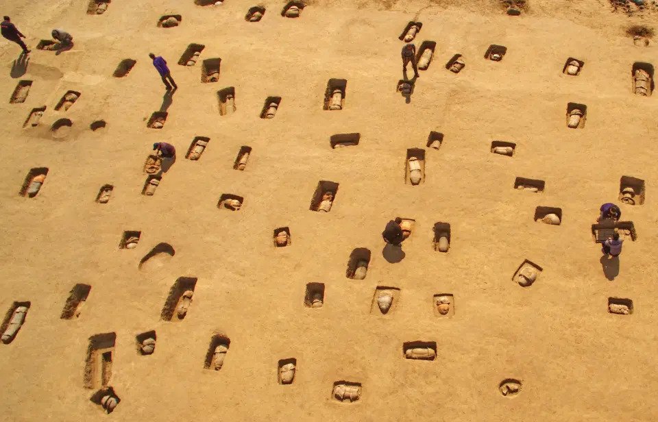 Haunting pictures show a mass grave of 113 ancient human remains buried in clay pots in China