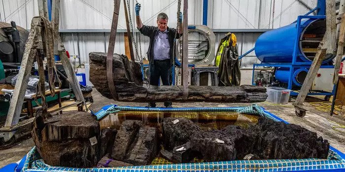 A coffin that was found in a golf course pond contains a 4,000-year-old man buried with an axe