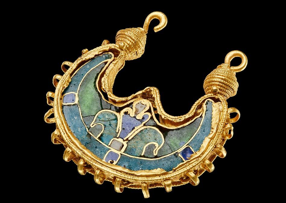 11th-century Gold earring discovered in Denmark A stunning gold earring discovered in Denmark may have been gifted by the Emperor of Byzantium to a Viking chief 1,000 years ago, experts claim. Dating from the 11th century, the 'completely unique' gold jewellery has never been seen before in the Nordic countries. Likely one of a pair, it was found by a metal detectorist in a field near Bøvling in West Jutland, Denmark. It's thought to have been originally crafted in Byzantium or Egypt and is potential evidence the Vikings had connections all the way around the Mediterranean. The Byzantine Empire (395 to 1204 and 1261 to 1453), also known as the Eastern Roman Empire or Byzantium, was a powerful civilization based at Constantinople (modern-day Istanbul). It's now being exhibited in Denmark National Museum's Viking exhibition 'Togtet', which translates as 'The Cruise' and is all about Viking travels to the Middle East. Experts have so far been unable to find a similar earring in the area that may have formed a pair. 'It is completely unique to us, we only know of 10 to 12 other specimens in the whole world, and we have never found one in Scandinavia before,' said Peter Pentz, inspector at the National Museum Denmark. 'We had expected to find such a fine and invaluable piece of jewellery like this together with a large gold treasure or in a royal tomb and not on a random field in Bøvling.' The find consists of a crescent-shaped gold plate inserted in a frame made of gold threads adorned with small gold balls and gold ribbons. Its crescent-shaped plate is covered with an enamel, now slightly cracked, which would have been created by a special technique involving breaking and powdering glass before melting it with metal so it becomes opaque. The motif of the enamel is two stylised birds around a tree or a plant, which symbolises the tree of life. This type of jewellery is known especially from Muslim Egypt and Syria and from Byzantium and Russia. In terms of style and craftsmanship, it's similar to the Dagmark cross – an 11th or 12th-century Byzantine relic. The earring and the Dagmark Cross are thought to both date from the Viking Age or the earliest Middle Ages and were likely not traded but donated by kings and emperors. That explains why the Dagmark cross was found in a queen's grave, at St. Bendt's Church in Ringsted, Denmark in 1683. In contrast, the new treasure was found in a field in Bøvling without known Viking sites nearby, so how it ended up there is therefore a bit of a mystery. The discoverer of the priceless find was 54-year-old Frants Fugl Vestergaard, who had searched the field many times before in the hunt for 'danefæ' – gold and silver in the earth without an owner. As his detector gave a faint bleep, he picked up a clump of earth and crushed it in his hand to find the earring peeping out. '